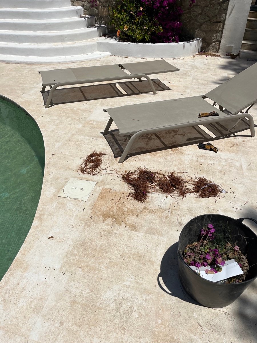 Pool terrace before cleaning, with dirt and debris