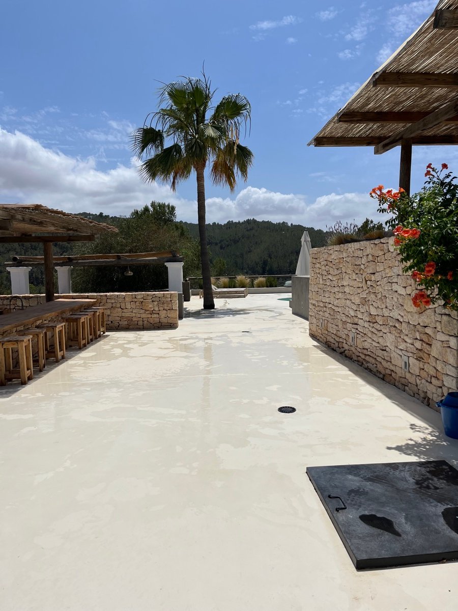Finished bright courtyard floor with palm tree at an Ibiza villa