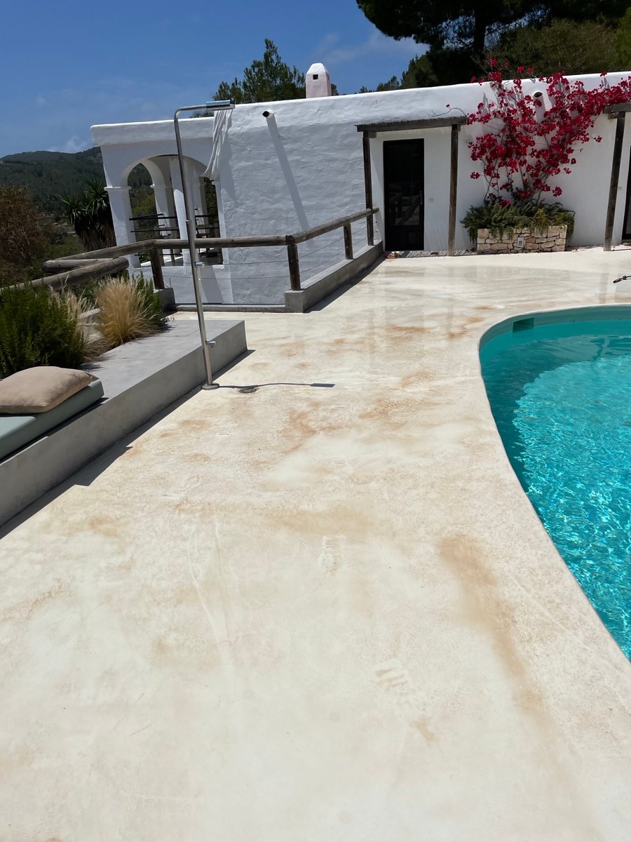 Clean white pool surround at an Ibiza villa